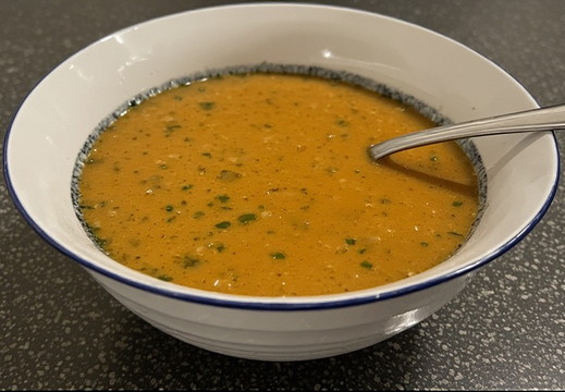 A bowl of creamy, orange soup