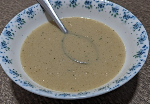 A bowl of creamy, light brown soup