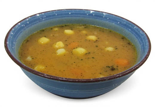 A deep blue ceramic bowl filled with a hearty soup