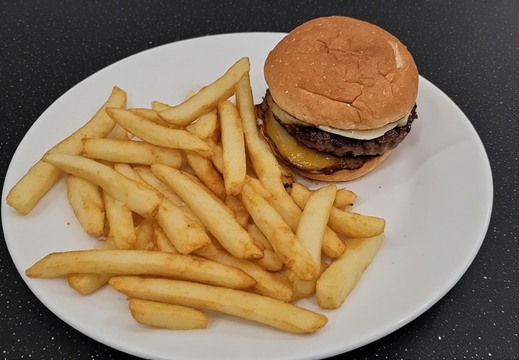 An elevated shot of a white plate filled with a classic fast-food meal