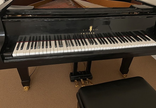 A glossy black grand piano