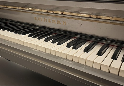 A close-up, low-angle, horizontal shot of a piano keyboard