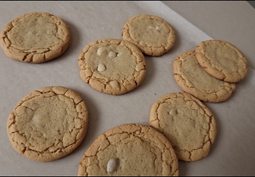 Eight cookies arranged on a sheet parchment paper