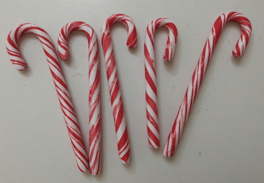Five red and white striped candy canes
