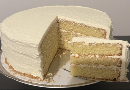 A beautiful, multi-layered cake with white frosting.