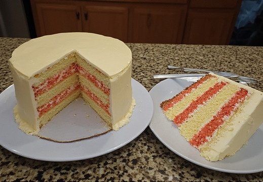 A beautifully crafted, multi-layered cake with a slice removed