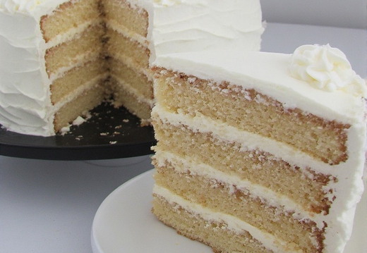 A delectable, multi-layered cake with a slice cut out and presented separately