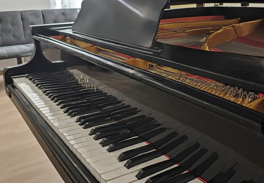 Low-angle view of a black grand piano.