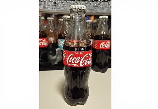 Several glass bottles of Coca-Cola