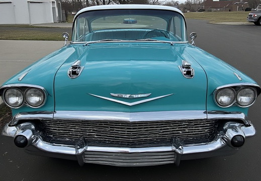The front view of a vintage turquoise and white two-tone Chevrolet Bel Air, from the late 1950s