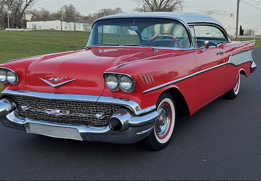A classic red and silver two-tone Chevrolet Bel Air from the late 1950s, likely a 1957 model