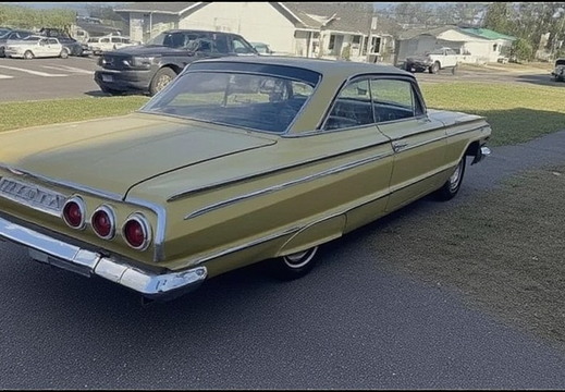A vintage, two-door coupe, likely a Chevrolet Impala from the early 1960s