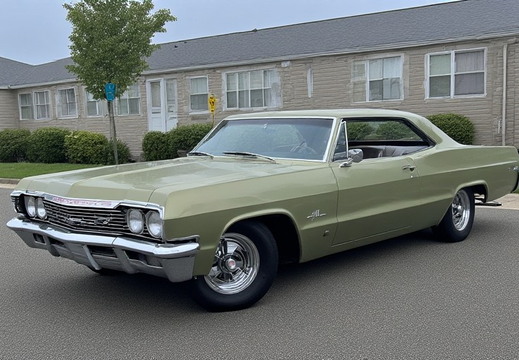 A vintage light green Chevrolet Impala coupe is parked on a wet asphalt road.