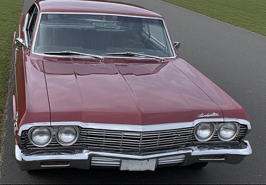 A close-up, high-angle shot of the front of a vintage car. 